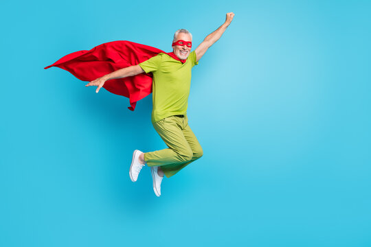 Full Length Body Size View Of Handsome Pensioner Retired Senior Cheery Superhero Jumping Having Fun Isolated Over Bright Blue Color Background