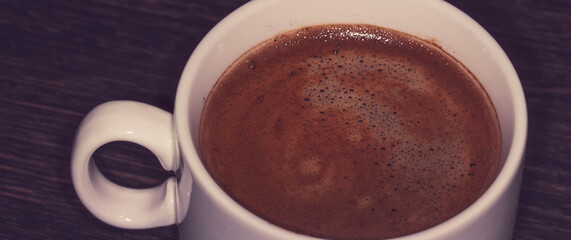 The texture of freshly brewed coffee close-up in a cup