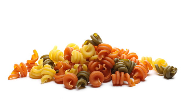 Pasta trottole tricolore pile made from durum wheat isolated on white background