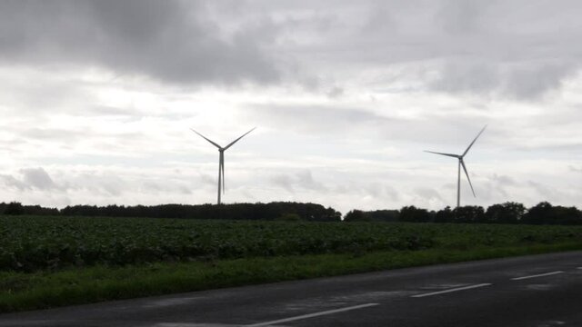 wind turbine in a field close to a highway