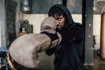 Obraz na płótnie Canvas black boxer. Punch to the camera, close-up