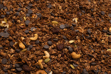 Chocolate granola cereal with nuts background.