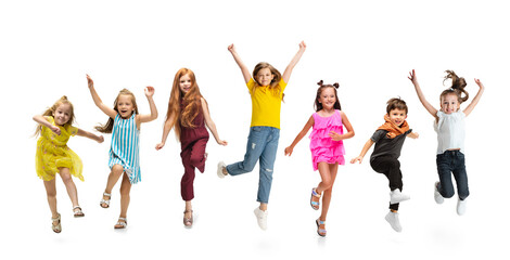 Group of elementary school kids or pupils jumping in colorful casual clothes on white studio background. Creative collage.