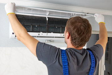 A professional technician starts servicing the air conditioner. Repair of climate control systems