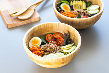 Brown rice salad with carrot, egg, cucumber, avocado, tomato and lamb's lettuce