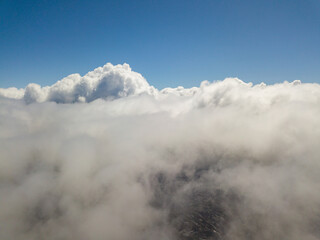 Flying in the clouds. Aerial high view.
