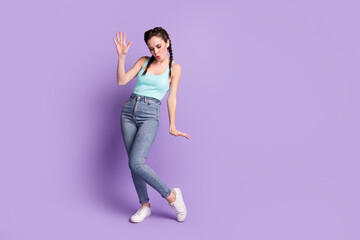 Fototapeta na wymiar Full body photo of funky joyful young woman dance wear casual outfit isolated on purple violet color background