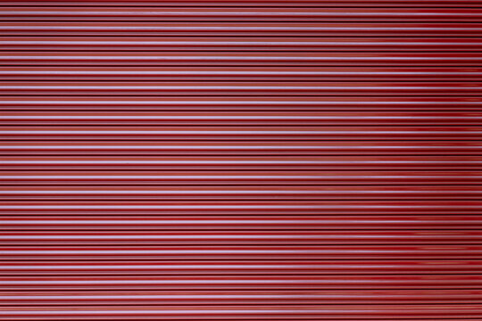 red steel shutter door background and texture. dark red striped metal background.