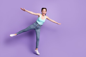 Full length body size view of pretty cheerful carefree girl flying having fun good mood isolated over violet purple color background