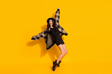 Obraz na płótnie Canvas Photo of crazy energetic lady dance stand tiptoe wear hat plaid coat mini dress boots isolated yellow color background
