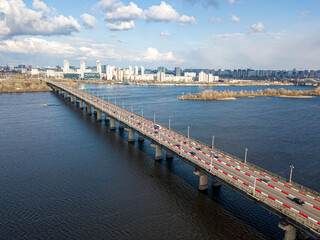 Obraz premium Automobile bridge across the Dnieper river in Kiev. Aerial drone view.