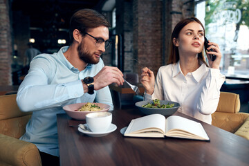 cheerful young couple in cafe breakfast work colleagues lifestyle