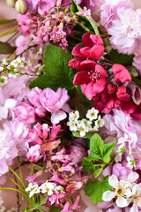 Floral background made of sakura flowers and green leaves.