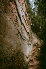 Hiking trail by the Licu and Langu sandstone cliffs by the Gauja river in Latvia