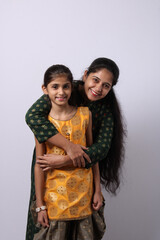 Indian mother daughter on white background. mothers day