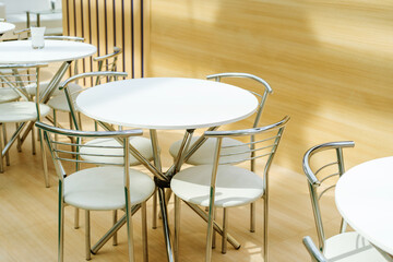 Round table and chairs. Kitchen furniture made of plastic and metal. Selective focus