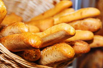Long form wheat bread in a wicker basket on the counter in the store. Close-up