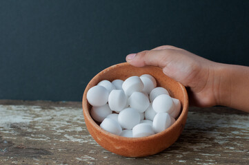 close-up white mothball or naphthalene over the wooden background