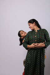 Indian mother daughter on white background. mothers day