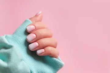 Foto op Canvas Gradient manicure and Hands Spa. Beautiful Woman hand closeup. Manicured nails and Soft hands skin. Beautiful woman's nails with beautiful baby boomer manicure, pink background. Copy space  © lelechka