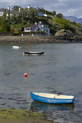 Fototapeta na wymiar Porthmadog north Wales. Picturesque bay of Borth-y-Gest. Vertical shot of small pleasure boats at low tide on a bright spring day. 