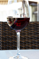 red wine in a large glass on the table in a summer cafe