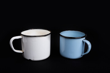 Old vintage enamel teapot and cup