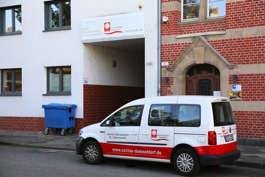 DUSSELDORF, GERMANY - SEPTEMBER 19, 2020: Caritas office and vehicle in Dusseldorf, Germany. Caritas is a Roman Catholic relief organization.