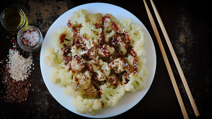 Chinese style cauliflower with soy sauce and sesame seeds. Healthly food. Vegan lunch.