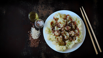 Chinese style cauliflower with soy sauce and sesame seeds. Healthly food. Vegan lunch.