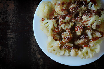 Chinese style cauliflower with soy sauce and sesame seeds. Healthly food. Vegan lunch.