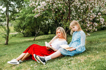 Mom and daughter walking in the park, reading books, socializing, laughter and fun, entertainment, hobbies