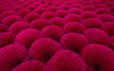 Making incense sticks drying outdoor in north of Vietnam. Red abstract background