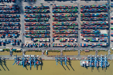 Fototapeta na wymiar Container ship working, Business import export logistic and transportation of International by container ship in the open sea, Aerial view industrial crane loading cargo freight port, Vietnam