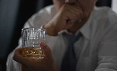A drink for the man. Cropped closeup of a man drinking whiskey at the bar.