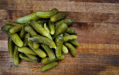 Crispy pickled cucumbers on a wooden board. Pickles.