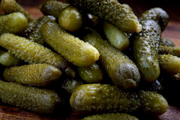 Crispy pickled cucumbers on a wooden board. Pickles.