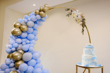 Photo zone with arch, balloons, flowers and cake on birthday party