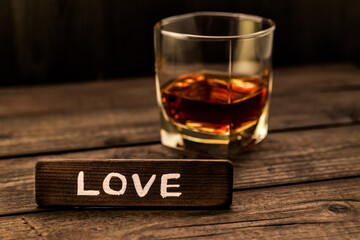 Glass of brandy with the wooden plank on it is an inscription 