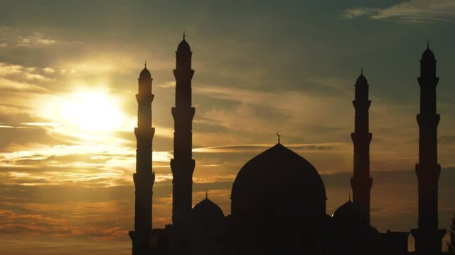 Muslim mosque against the background of the rising sun.