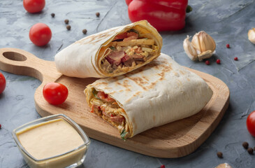 Shawarma with meat and vegetables. Shawarma with sauce. Shawarma in lavash. Lavash with meat and vegetables