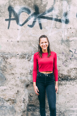 Young woman outdoors posing looking camera smiling