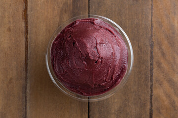 Açai, Brazilian frozen açai berry ice cream bowl. with fruits on wooden background. Summer menu top view