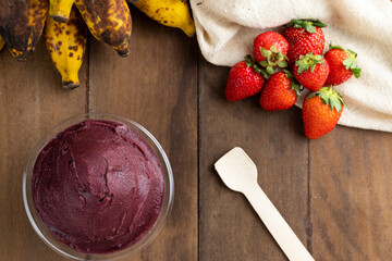 Açai, Brazilian frozen açai berry ice cream bowl. with fruits on wooden background. Summer menu top view