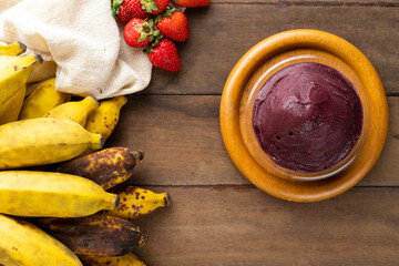 Açai, Brazilian frozen açai berry ice cream bowl. with fruits on wooden background. Summer menu top view