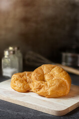 Close up of a pile of delicious croissants Homemade on a dark background. And bread making equipment for a restaurant dish has copy space, Front view, Vertical.