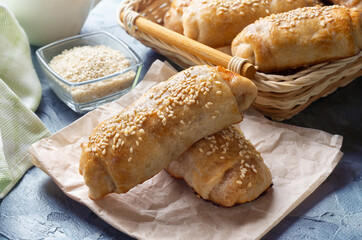 Cabbage pies. Puff pastry sprinkled with sesame seeds. Puff pastry with cabbage.