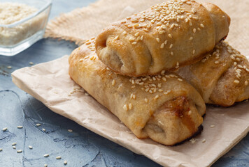 Cabbage pies. Puff pastry sprinkled with sesame seeds. Puff pastry with cabbage.