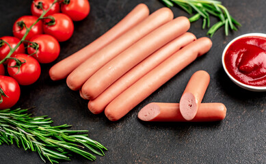 Raw sausages on stone background