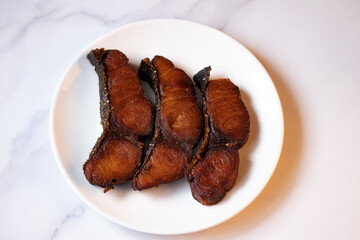 Fried salted fish in white plate